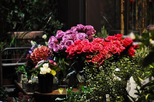 Red an purple roses on a florist stall