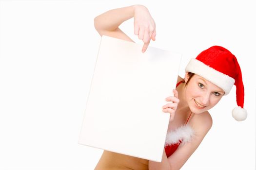 Beautifull girl in christmas bikini and with christmas hat is hlding up a white sign for copy space. With background clipping path for your convenience
