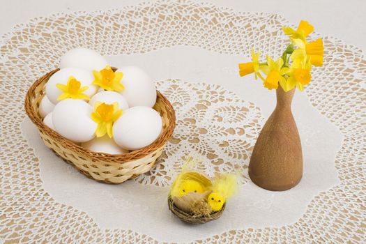 a basket of eggs, easter chicken and yellow daffodils