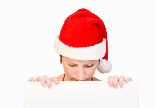 Beautiful girl in christmas bikini and with christmas hat is holding up a white sign for copy space. With background clipping path for your convenience