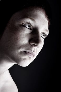 Studio portrait of a young woman with short hair looking mysterious