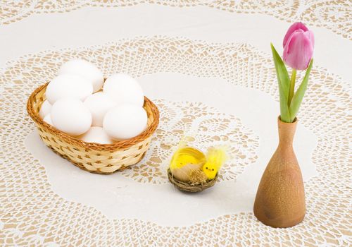 a basket of eggs, easter chicken and a pink tulip