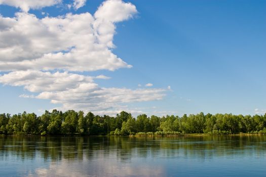 Landscape series: river and forest ander blu cloudy sky