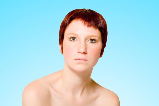 Studio portrait of a young woman with short hair looking neutral