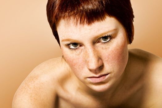 Studio portrait of a young woman with short hair looking serious