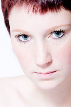 Studio portrait of a young woman with short hair making eye contact