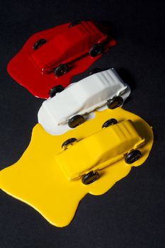 Small copies of sports automobiles filled with a paint