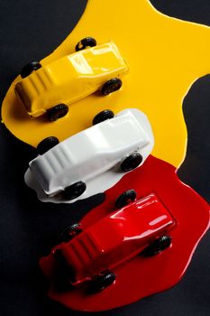 Small copies of sports automobiles filled with a paint