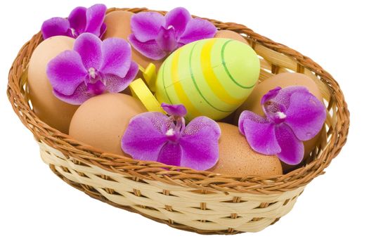 a basket of  easter eggs with flowers isolated on the white background