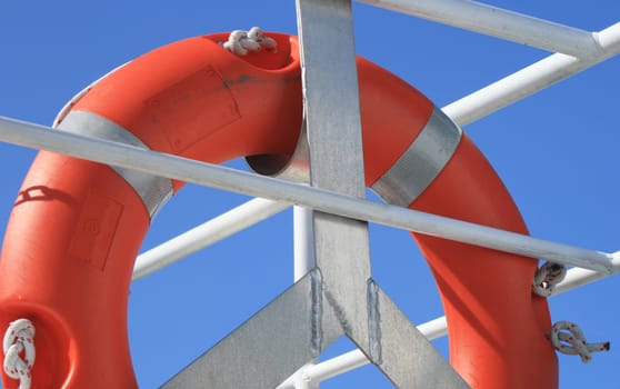 Fixed life belt on a ship with blue background.