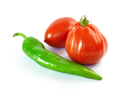 Tomatoes and green pepper on white background