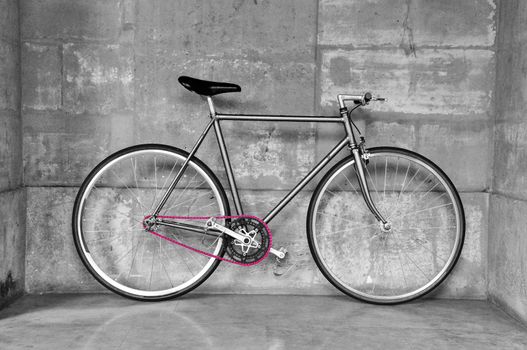 Vintage fixed-gear bicycle with a pink chain