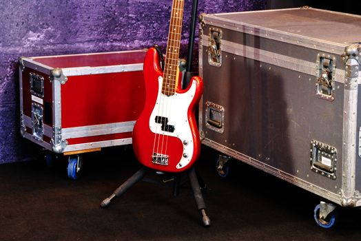 A red bass guitar on a stage