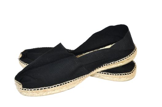 Black pair of espadrilles on a white background