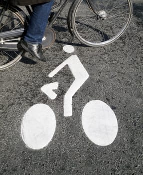 Cyclist sign painted on the road, a bicycle passing by