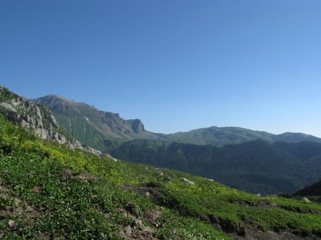 Mountains, rocks; a relief; a landscape; a hill; a panorama; Caucasus; top; a slope; clouds; the sky; a landscape