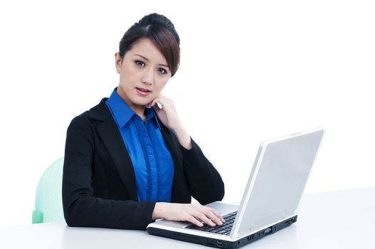 Portrait of an attractive young businesswoman using laptop over white background.