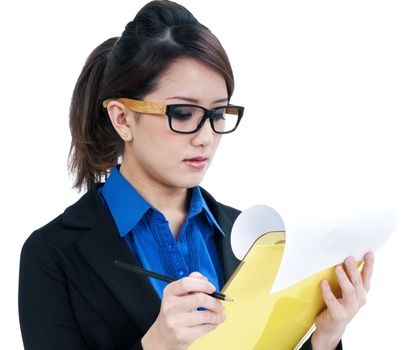 Portrait of an attractive young businesswoman holding and looking at clipboard, isolated on white background.