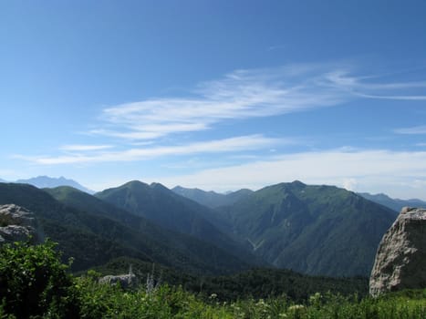 Mountains, rocks; a relief; a landscape; a hill; a panorama; Caucasus; top; a slope; clouds; the sky; a landscape