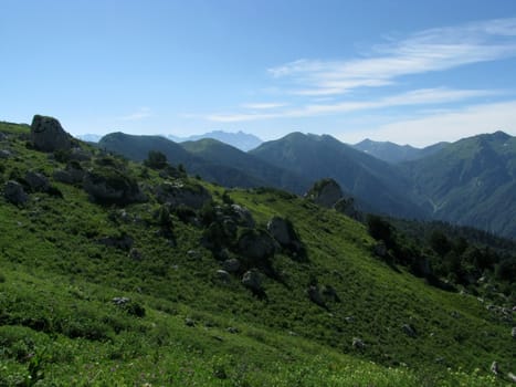 Mountains, rocks; a relief; a landscape; a hill; a panorama; Caucasus; top; a slope; clouds; the sky; a landscape