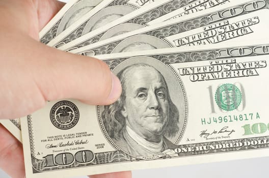 Close up view of hand with pack dollar banknotes