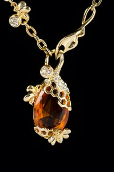 pendant closeup with big gem at black background
