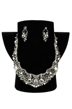 a necklace with pendants and earrings on a white background