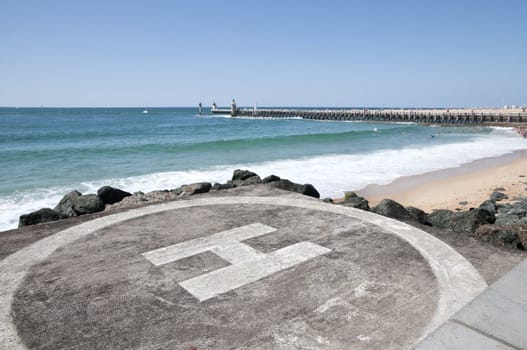 Landing area on the beach with sea and a jetty in the background during a beautiful day