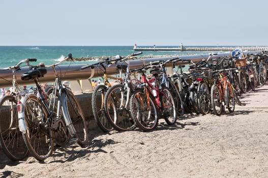 Many bikes along the beach during a beautiful day