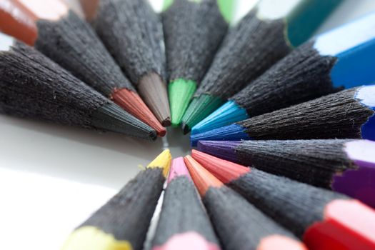 A circle of colored pencils. Made from black wood.