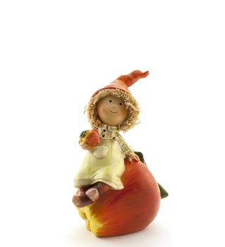 Figurine of a boy sitting on a big red apple