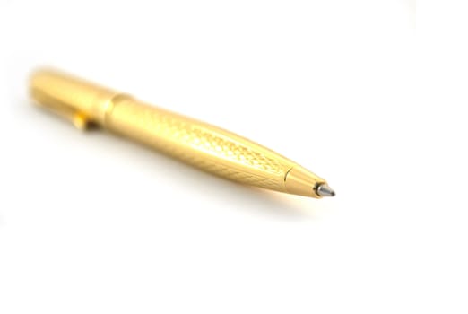 The golden pen on a white background closeup