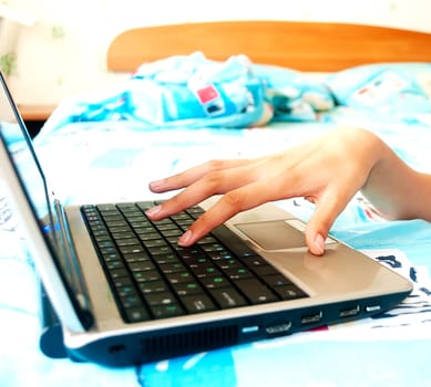 female hands typing on a silver laptop