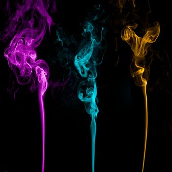 Three Colorful Smoke on black background.