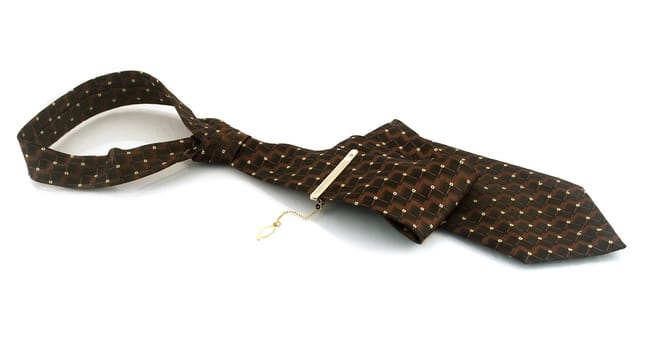 Tie with a gold pin on a white background