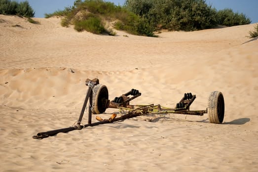 an abandoned trolley to transport the boat in the desert