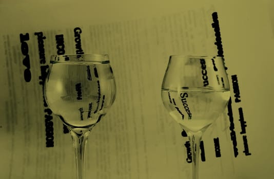 Two glasses with water, black and white background.