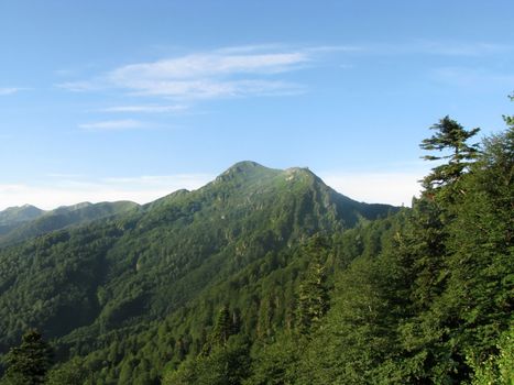 Mountains, rocks; a relief; a landscape; a hill; a panorama; Caucasus; top; a slope; clouds; the sky; a landscape