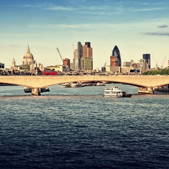 City of London in late afternoon light. This view includes: St. Paul`s Cathedral, The Gherkin, Tower 42, and Waterloo Bridge.