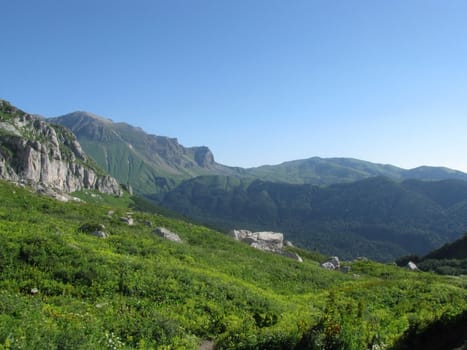 Mountains, rocks; a relief; a landscape; a hill; a panorama; Caucasus; top; a slope; clouds; the sky; a landscape