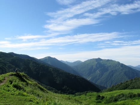 Mountains, rocks; a relief; a landscape; a hill; a panorama; Caucasus; top; a slope; clouds; the sky; a landscape