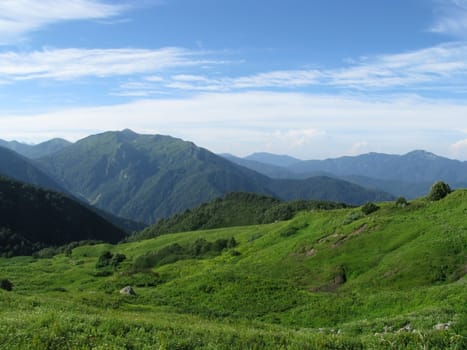 Mountains, rocks; a relief; a landscape; a hill; a panorama; Caucasus; top; a slope; clouds; the sky; a landscape