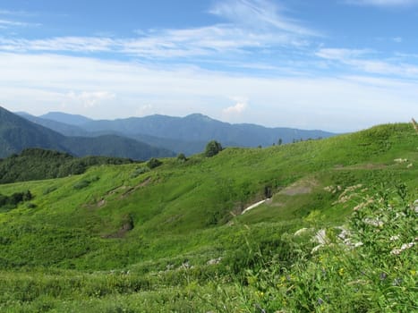 Mountains, rocks; a relief; a landscape; a hill; a panorama; Caucasus; top; a slope; clouds; the sky; a landscape