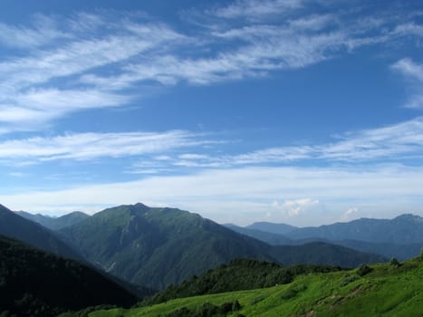 Mountains, rocks; a relief; a landscape; a hill; a panorama; Caucasus; top; a slope; clouds; the sky; a landscape