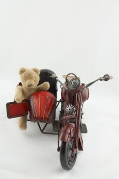 Teddy bear on a vintage motorbike toy