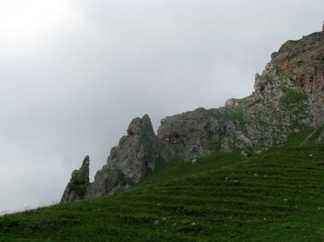 Mountains; rocks; a relief; a landscape; a hill; a panorama; Caucasus; top; a slope; clouds; the sky; a landscape