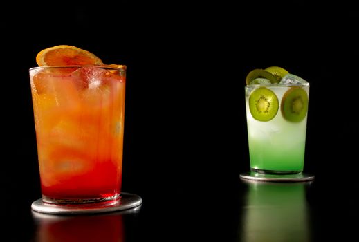 Two designer cocktails isolated on black background