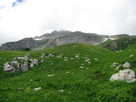 Mountains; rocks; a relief; a landscape; a hill; a panorama; Caucasus; top; a slope; clouds; the sky; a landscape