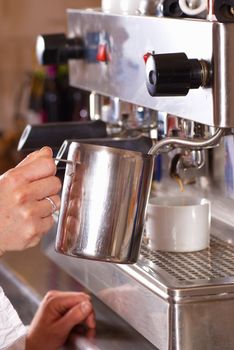 Operating a professional italian coffee machine in a cafe