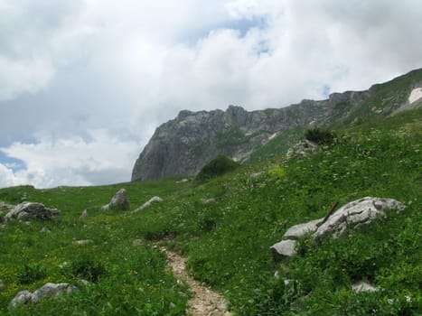 Mountains; rocks; a relief; a landscape; a hill; a panorama; Caucasus; top; a slope; clouds; the sky; a landscape